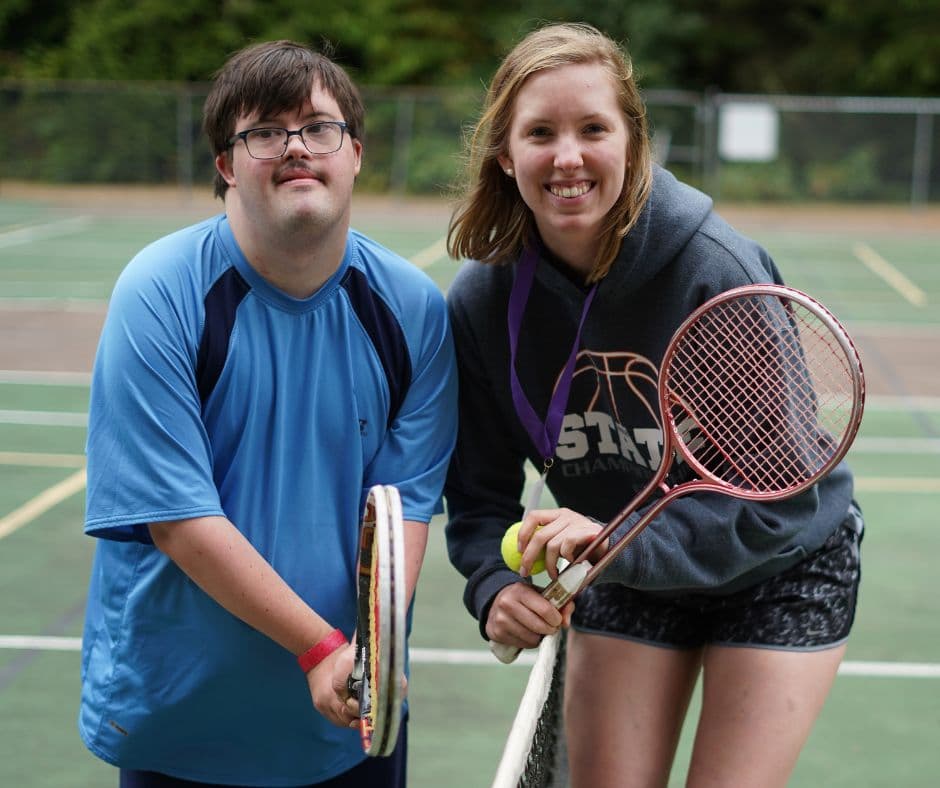 Participant and support worker enjoying an activity together outdoors
